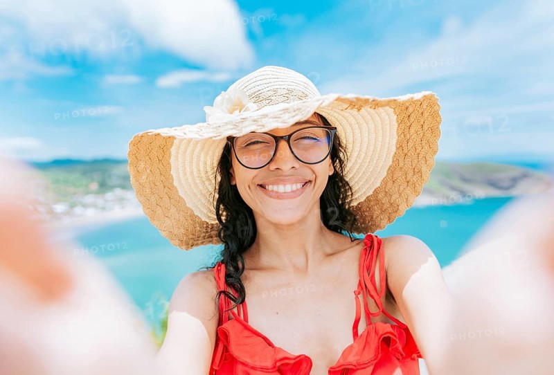 Beautiful tourist girl taking a selfie on the beach. Happy tourist girl taking a selfie on the beach of San Juan del Sur