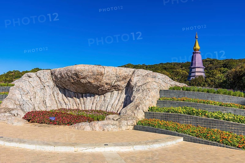 Monumental rock formation in an artfully landscaped garden with the King's Pagoda in the back, Doi Inthanon National Park, Chiang Mai Province, Thailand