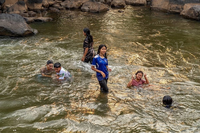 Children bathing in the Tad Lo river, Bolaven Plateau, Laos