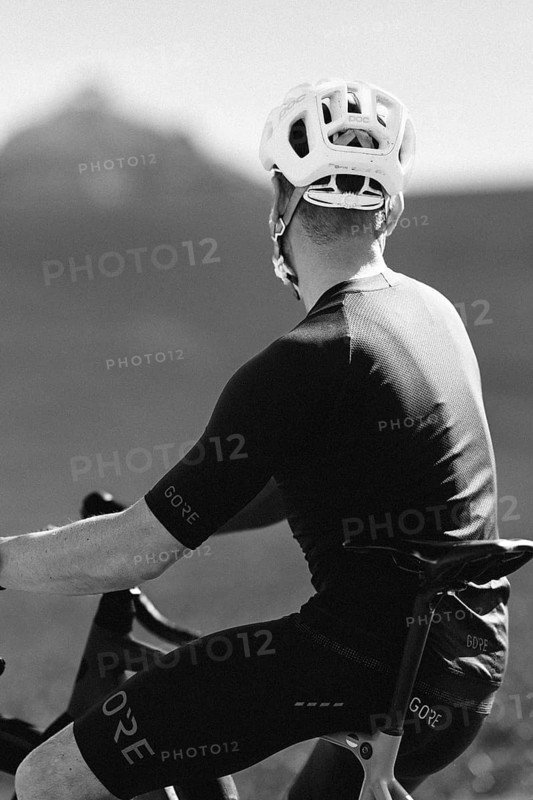 Road bike rider in spring in the Allgäu against the picturesque backdrop of the Alps, Bavaria, Germany