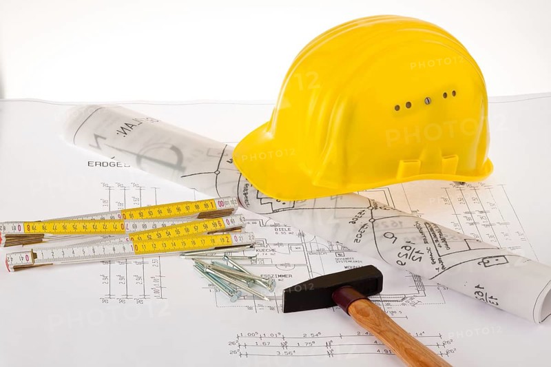Construction plan for a residential building, drawings and plans by an architect, hammer, folding rule, safety helmet, craftsman, construction worker, architect