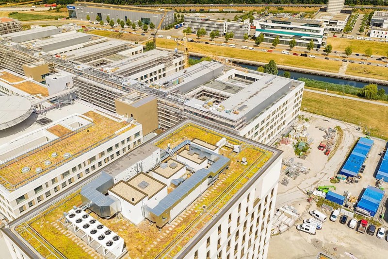 Industrial urban area with modern buildings, roads and construction machinery on an extensive area, new hospital building, Böblingen airfield, Germany