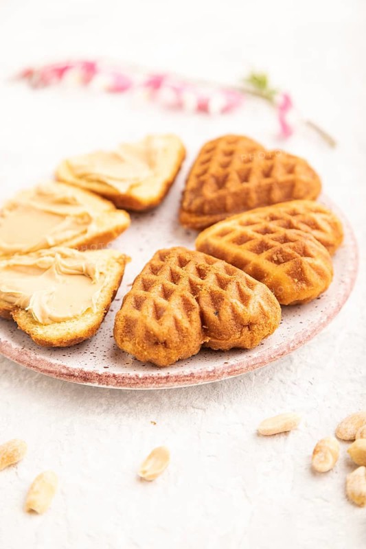 Homemade waffle with peanut butter and cup of coffee on a gray concrete background. side view, close up, selective focus