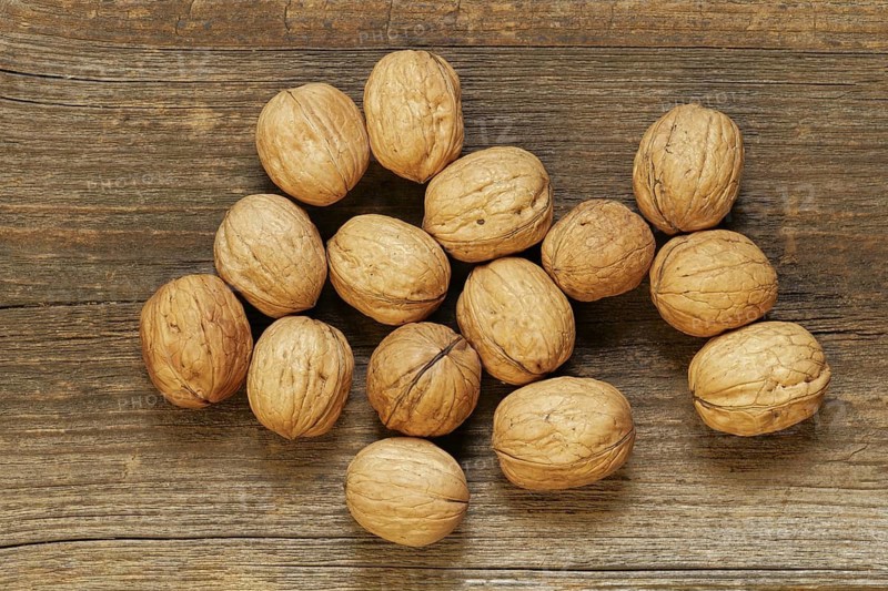 Walnuts lying on an old brown board. view from the top