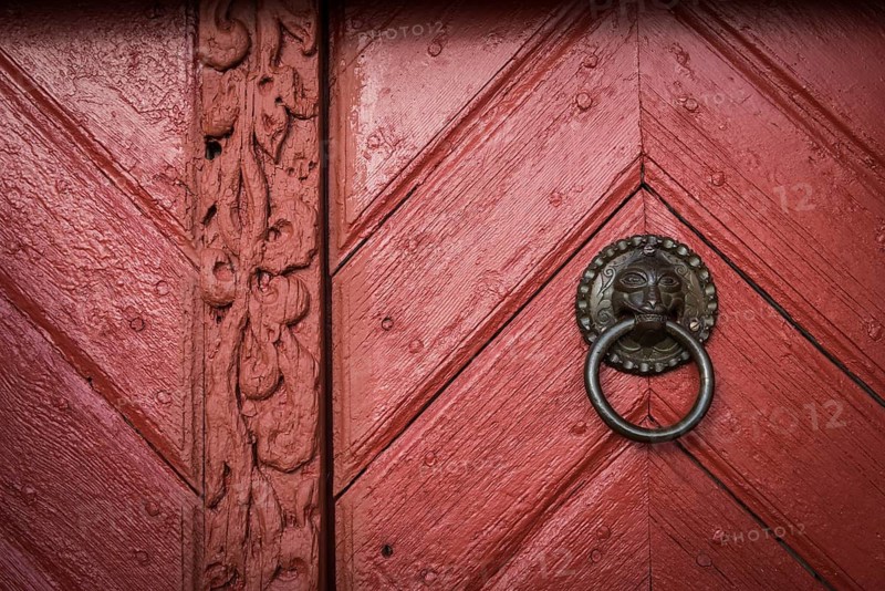 Red wooden door, door handle, Skarð á Skarðsströnd vicarage, Dalabyggð, Klofningsnes peninsula, Breiðafjörður, Iceland