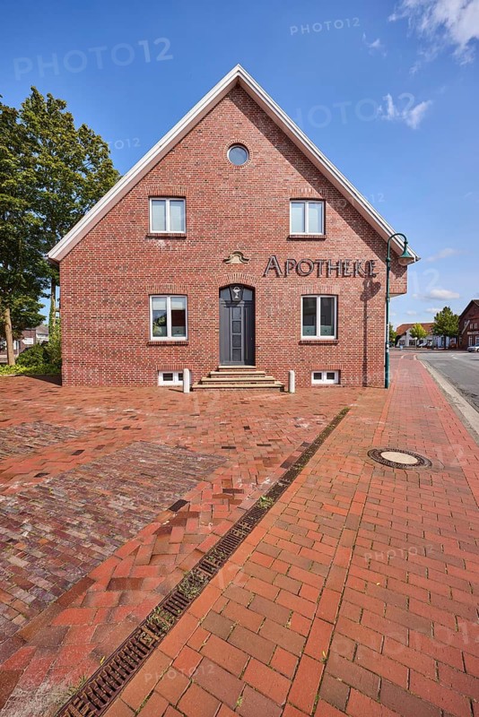 Pharmacy, brick building, blue sky with fair weather clouds, Bohlenberger Straße, Zetel, district of Friesland, Lower Saxony, Germany