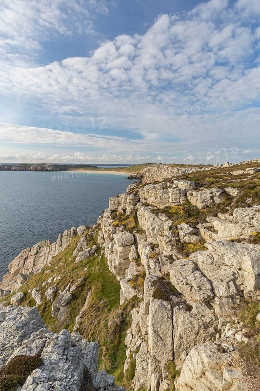 Rocky coast of Camaret-sur-Mer in the Finistère department in northwestern France, with a partly cloudy sky