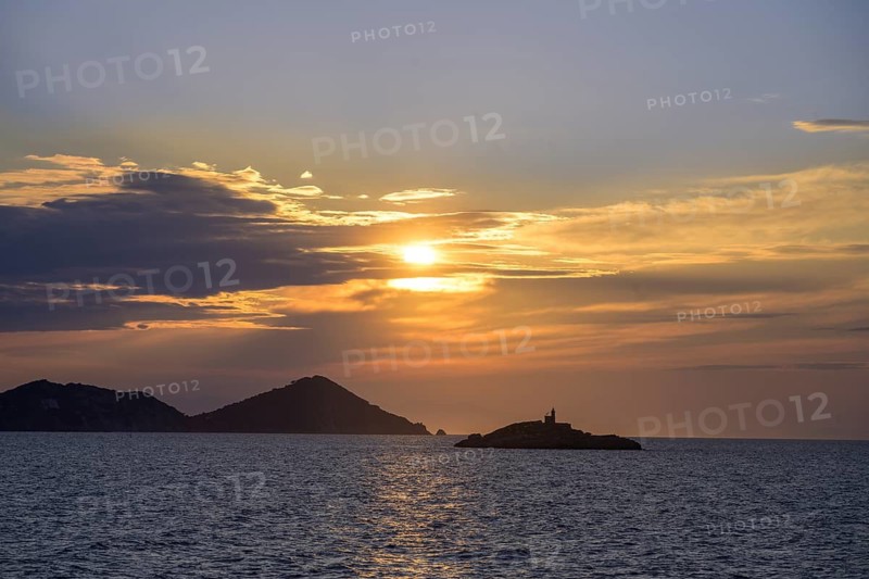 Small lighthouse at sunset on Lo Scoglietto, Arcipelago Toscano, ferry trip to Elba, Livorno province, Italy
