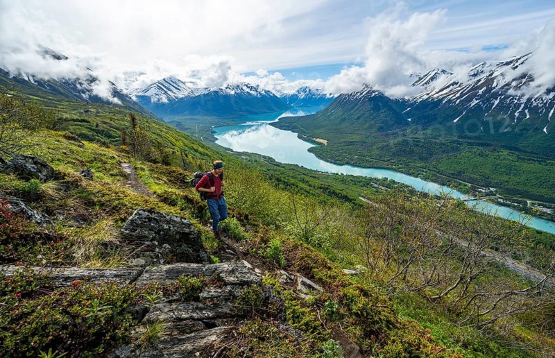 Climbers on a hiking trail, Slaughter Ridge Trail, view of snowy mountains and turquoise lake Kenai Lake, Cooper Landing, Kenai Peninsula, Alaska, USA