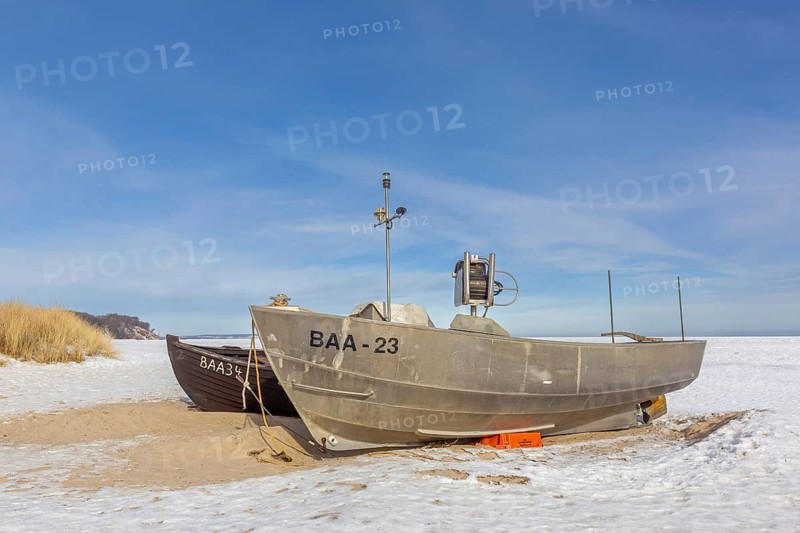 Fishing boats on snow covered beach in winter along the Baltic Sea at Baabe, Mönchgut peninsula, Island Rügen, Mecklenburg Western Pomerania, Germany