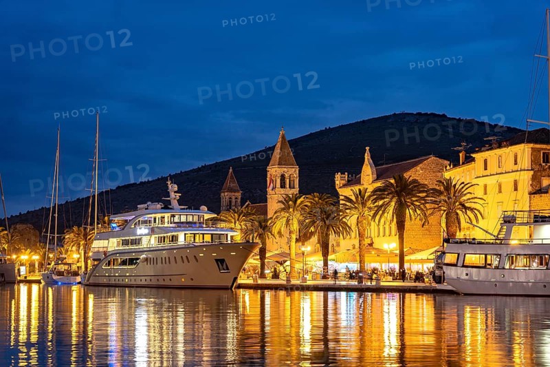 Cruise ships in front of the old town centre of Trogir at dusk, Croatia