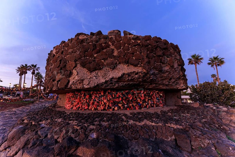 Lanzarote, Canary Islands, Spain, Europe, Playa Blanca, Love Castles, A round stone building with love locks in the evening, surrounded by palm trees