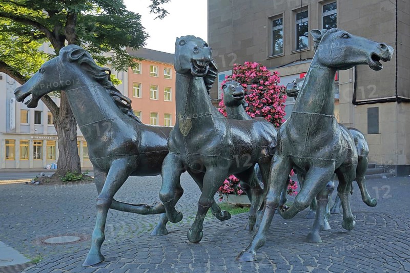 Group of horses sculpture by Boniface Stirnberg 1975 at the main train station in Art Nouveau style, modern art, life-size, bronze sculptures, sculpture group, black running horse figures, station building, Aachen, Eifel, North Rhine-Westphalia, Germany
