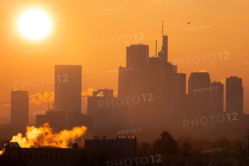 The sun rises behind Frankfurt's banking skyline, Frankfurt am Main, Hesse, Germany
