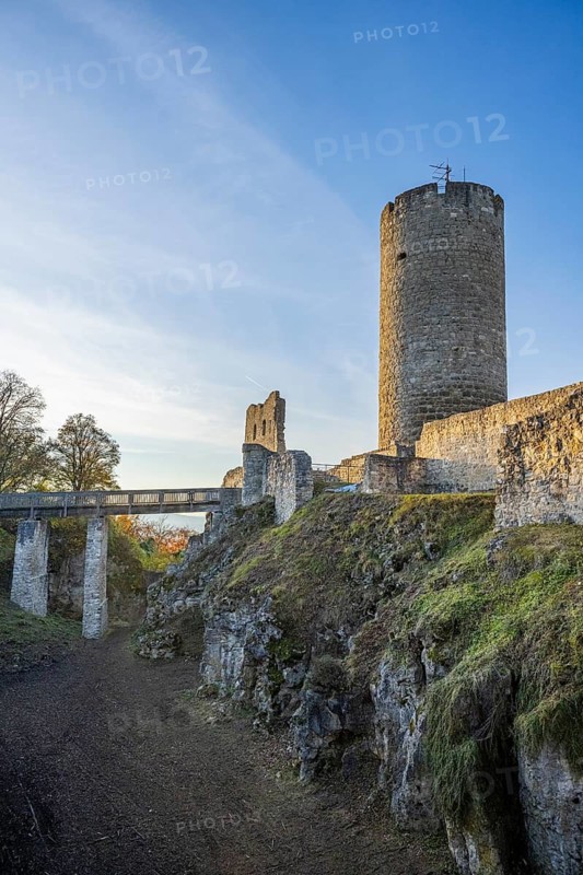 Mighty castle ruins on a hill in the evening sun, surrounded by landscape and trees, Wolfstein castle ruins, Neumarkt in der Upper Palatinate