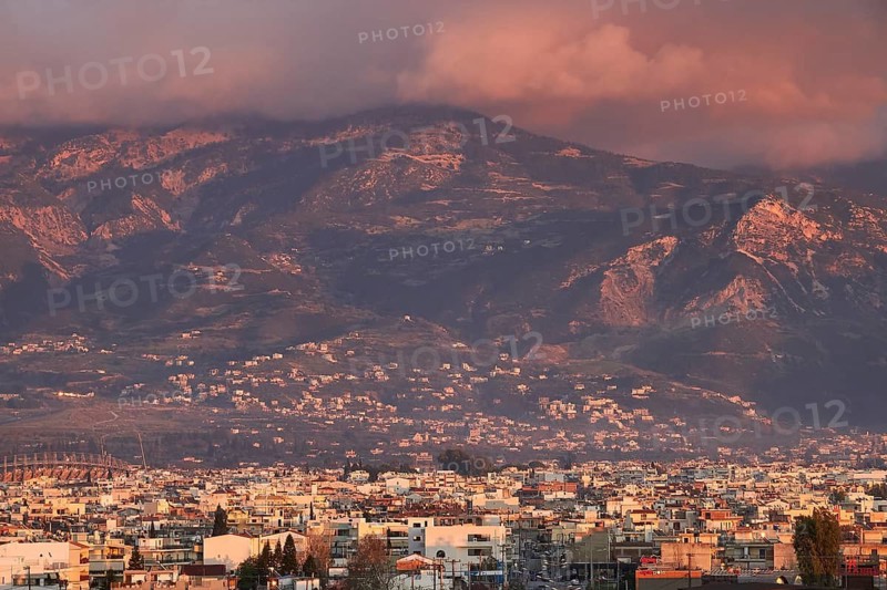 Urban panorama with mountains in the background at setting sun, Patras, Peloponnese, Greece