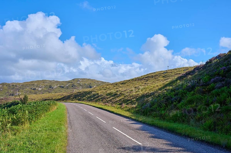 Lonely road snakes through green hills under a clear sky, Gruinard Beach, First Coast, Little Gruinard, Achnasheen, Scotland, United Kingdom, Great Britain