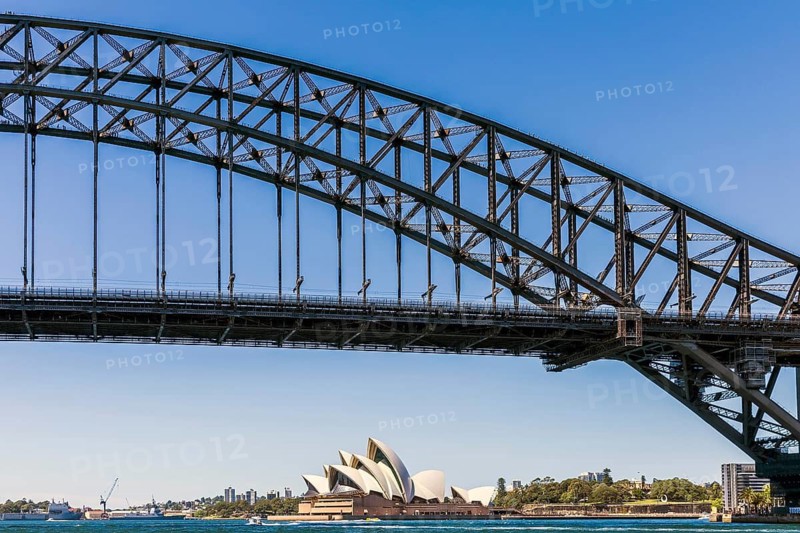 Iconic architectural masterpiece Sydney Opera House with its unique sail-like design on a sunny afternoon framed by the Harbour Bridge, Sydney, Australia