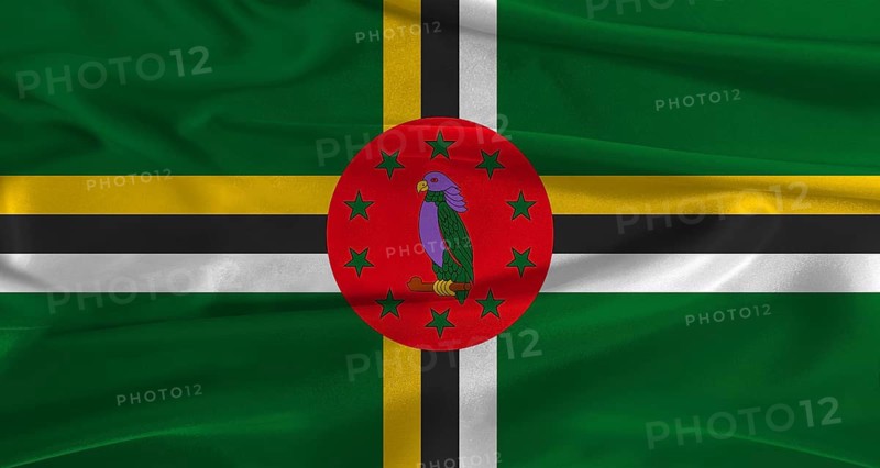Flag of Dominica with fabric textured background. Close up of National flag of Dominica with realistic texture