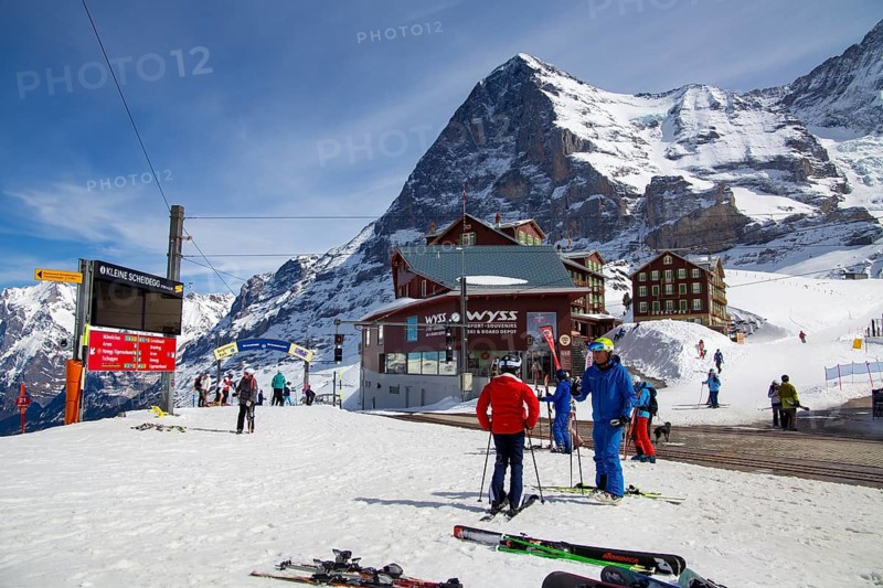 25 March 2024, Kleine Scheidegg, Grindelwald Switzerland : Many skiers and tourists enjoy the sunny winter weather. The famous north face of the Eiger in the background