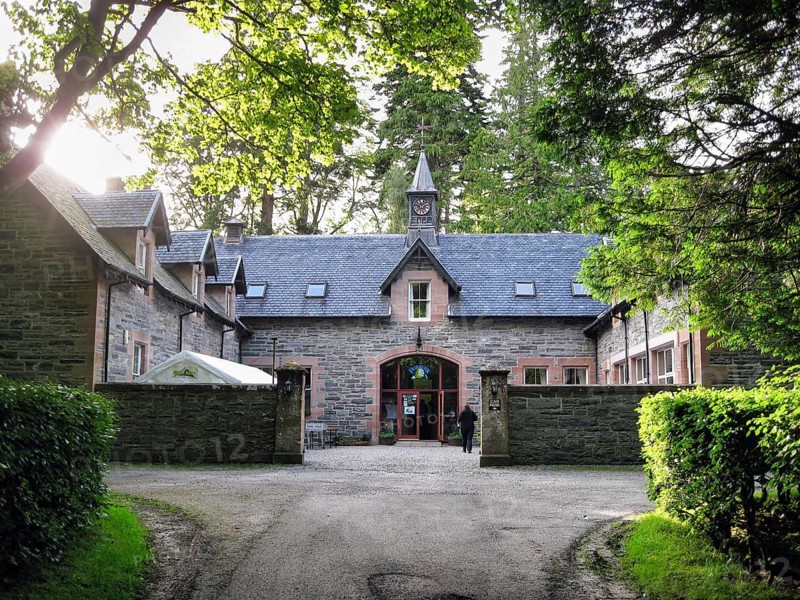 Fairburn Activity Centre, accommodation and café, former converted Victorian horse stable, distinctive stone building with clock tower, Marybank, Muir of Ord, Strathconon Glen, Scottish Highlands, Scotland, United Kingdom