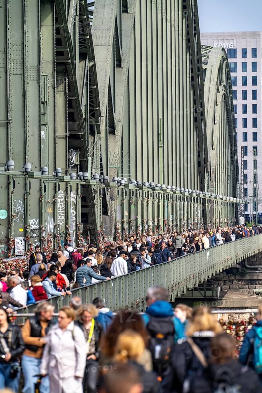 The Hohenzollern Bridge, railway bridge over the Rhine near Cologne, multi-track Rhine bridge to, from Cologne Central Station, tourists, people on the cycle and footpath, North Rhine-Westphalia, Germany