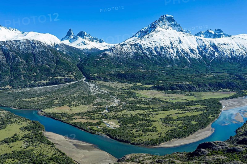 Confluence of river Estero Parada flowing into Rio Ibanez, aerial view at Mirador Rio Ibanez, snow-capped mountains in early spring, Patagonia, Chile