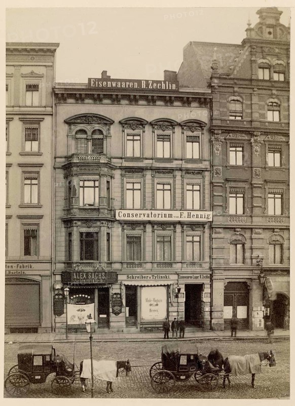 Alexanderstr. 49, Berlin, Mitte, Conservatorium, small businesses, historic city facades with shops and parked horse-drawn carriages, around 1878