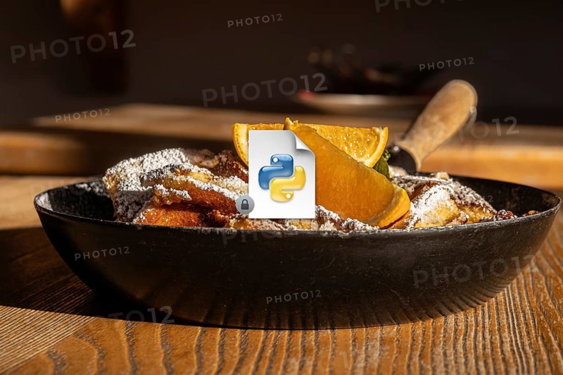 Serving of Austrian Kaiserschmarrn, a shredded pancake, dusted with powdered sugar and accompanied by fresh orange slices in a cast iron skillet