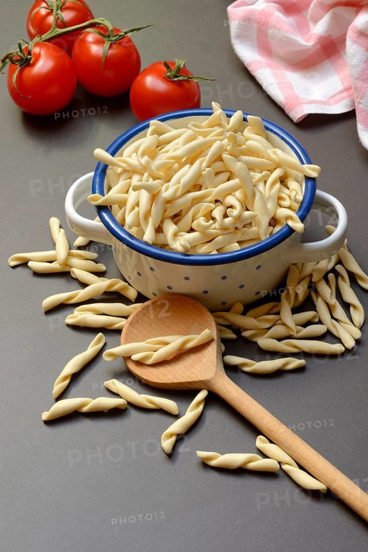 Uncooked strozzapreti, Italian type of pasta in pot