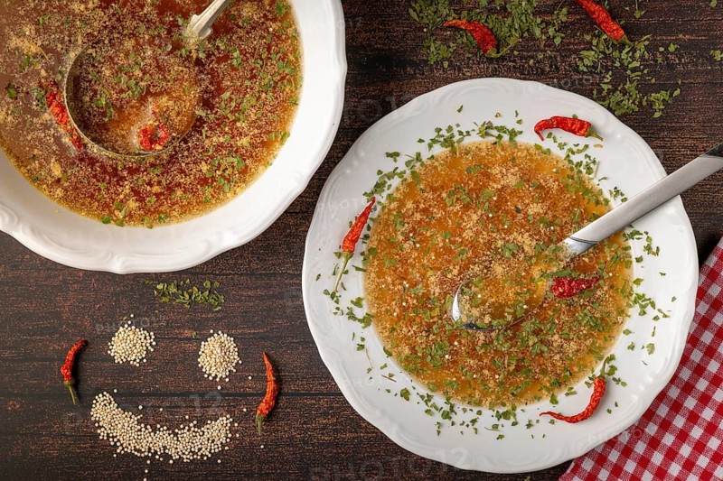 Soup plate with a quinoa face next to it, decorated with chilies