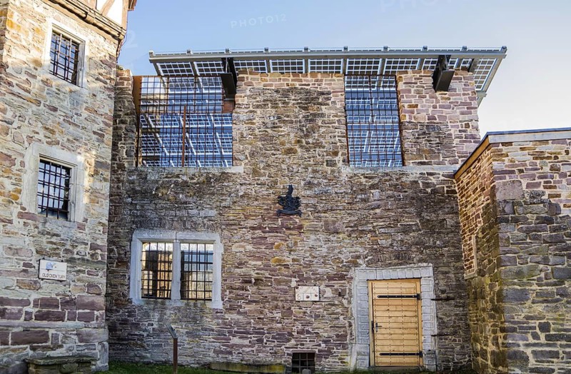 Old castle with modern photovoltaic system as the roof of the concert hall, Wülmersen moated castle, Trendelburg, Hesse, Germany