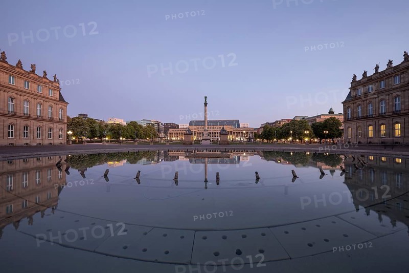 24.4.2026: Symmetrical reflection of the Jubilee Column and Koenigsbau in a fountain on Schlossplatz at dawn. Early morning atmosphere. Stuttgart, Baden Wuerttemberg, Germany