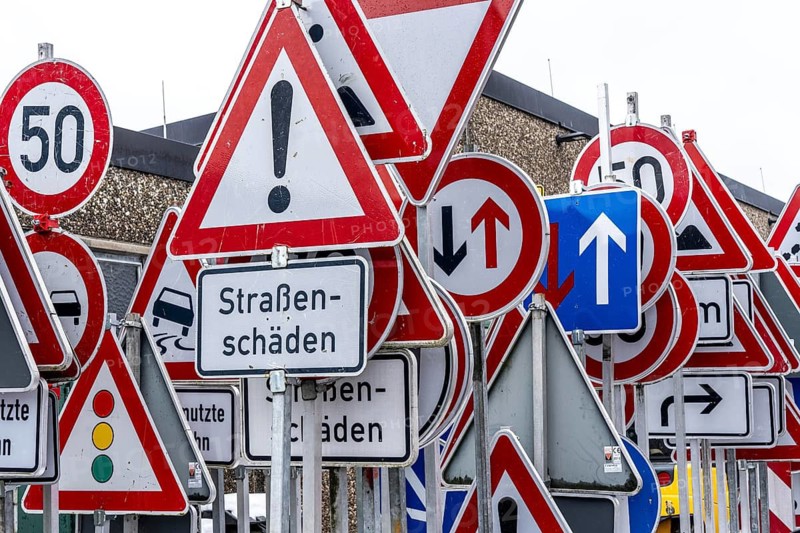 Storage for traffic signs in the yard of a road maintenance department, various signs with commandments and prohibitions, information about dangers, road traffic