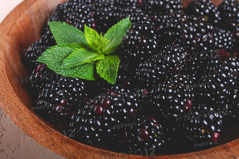 Blackberries, in a wooden bowl, top view, no people