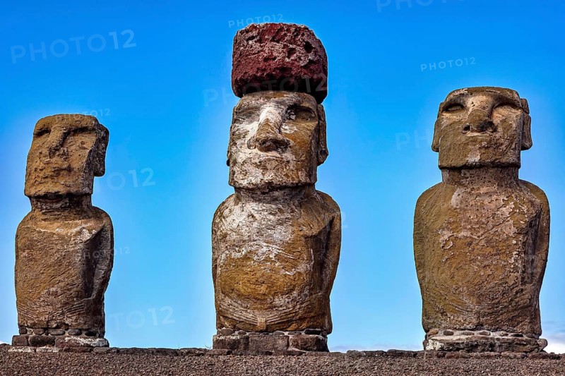 Three Moai statues stand under a clear blue sky, The Moai Statues on Easter Island in the Pacific Ocean