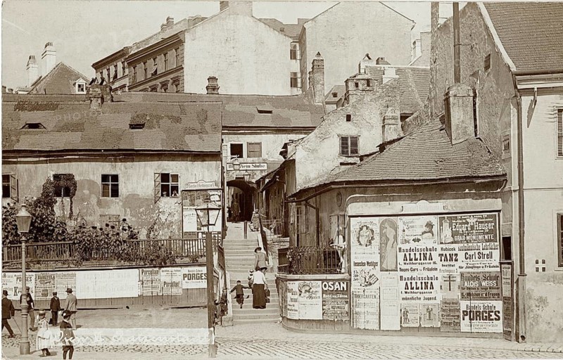 Vienna, advertising posters on the walls, small staircase, Old Vienna, old buildings with many advertising posters, central street with pedestrians in historic surroundings, 1911