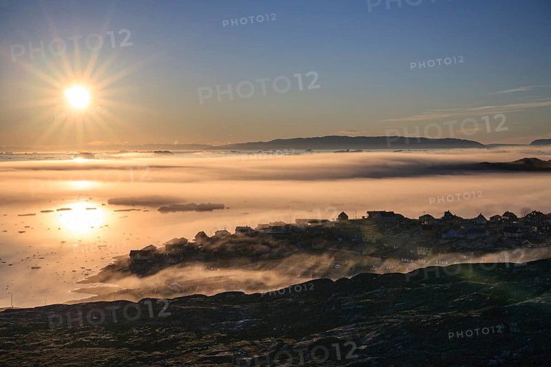 Inuit settlement in front of icebergs in the fog, midnight sun, summer, Ilulissat, Ilulissat Icefjord, Disko Bay, West Greenland, Greenland
