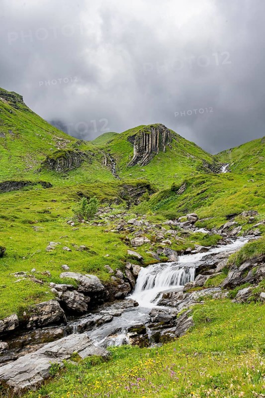 Bergbach Sousbach flows through picturesque green mountain landscape, long exposure, Bernese Alps, Bernese Oberland, Switzerland