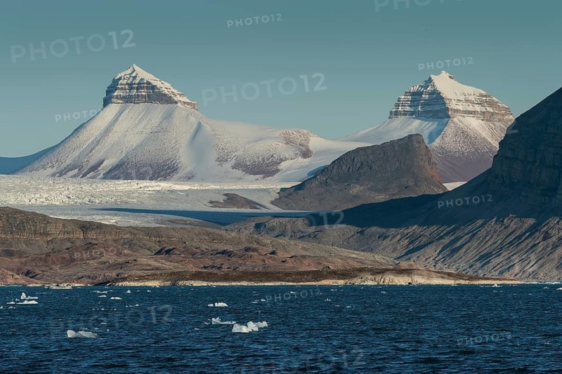 A fjord with ice floes and two of the three mountains: Tee Kroner (Three Crowns), Kronebreen or Kronengletscher Glacier, Kongsfjord or Kongsfjorden, the Svalbard archipelago, Svalbard, Norway