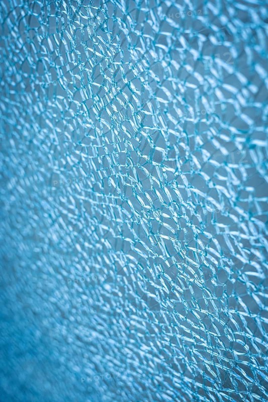 Frozen abstract texture resembling winter frost or cracked ice surface. Delicate crystalline pattern with cold blue tones creating seasonal atmosphere, frozen nature background and icy winter feeling