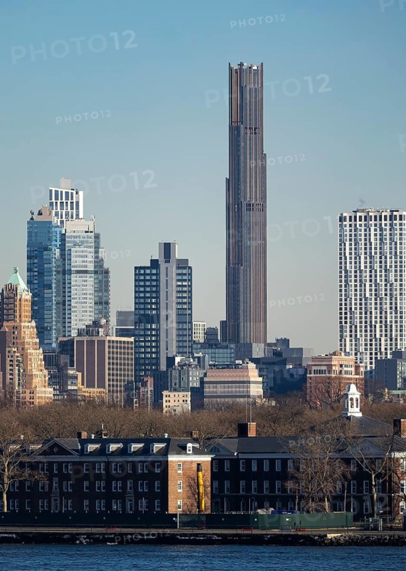 A striking contrast of New York City's modern skyscrapers and older historic buildings captured along the waterfront, showcasing architectural diversity