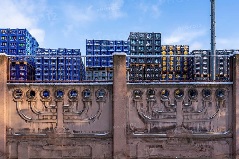 Menorah, seven-armed Judaism chandelier, on a wall in winter, piles of boxes with drinks in the back, Weissensee Jewish Cemetery, Berlin Pankow-Weissensee, Germany