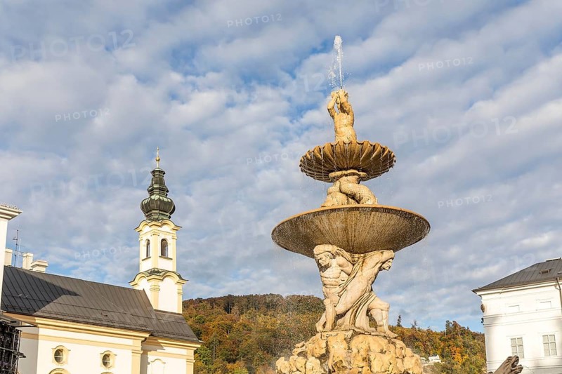 Residenzbrunnen am Residenzplatz, with the tower of St. Michael's Church in the background, Salzburg, Austria
