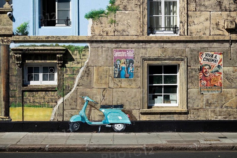 A turquoise painted roller on an illusionistically painted house façade and vintage posters, 143 Old Church Street, Royal Borough of Kensington and Chelsea, London, Great Britain, England, Great Britain