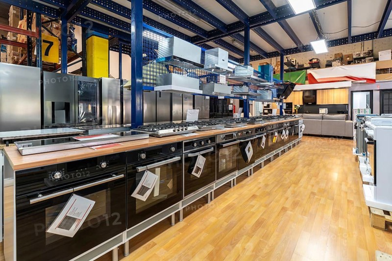 Appliance showroom offering a wide selection of modern ovens, hobs, and refrigerators for sale, providing options for new kitchen design or home renovation projects