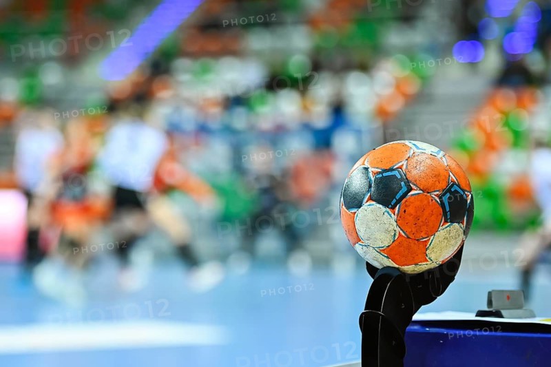 Handball ball and blurred match in the background.