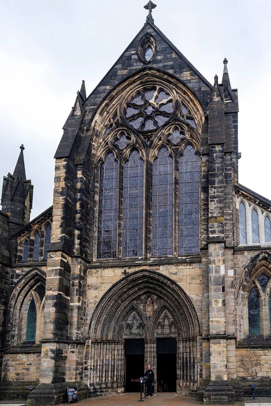 Pointed gothic doorway and rose window mark the imposing west front of Glasgow Cathedral, Scotland, United Kingdom