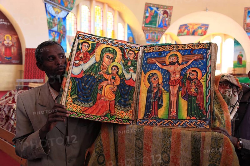 Tigray region, Axum, Aksum, St Mary's Cathedral, Maryam Tsion, inside, church servant shows old bible of the cathedral, Ethiopia