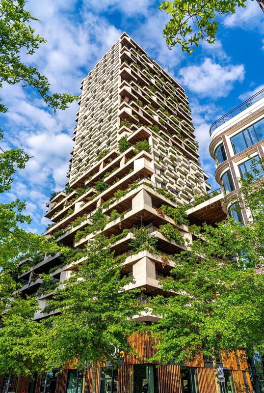 Wonderwoods residential tower, one of 2 green buildings, in Utrecht in the new Healthy Urban Quarter, at the central station, 105 metres high with 30 floors, Tower II, over 360 trees and over 9600 shrubs and flowering plants native to the region, all irrigated with collected rainwater, sponge city principle and monitored with sensors, Utrecht, Netherlands